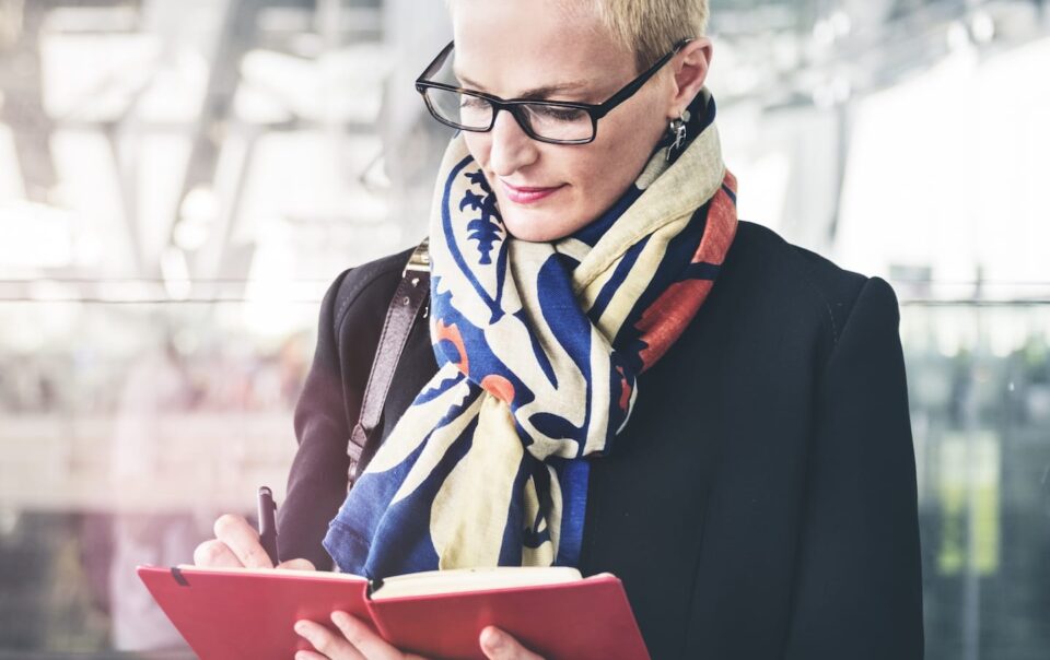 Business woman writing in her notepad