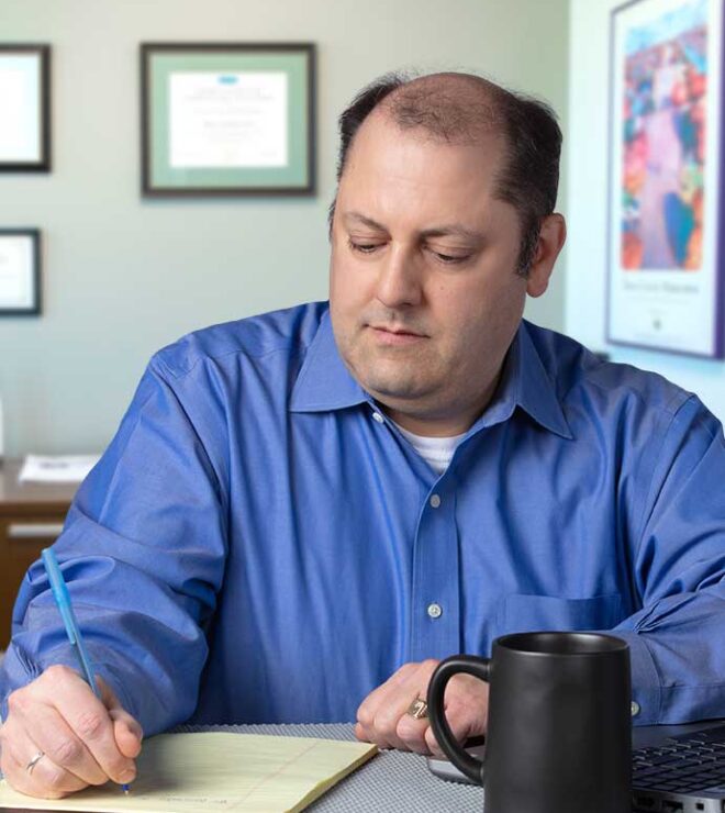 Marc Kotsonas with pad and paper