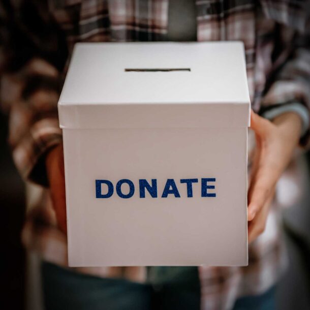 Close up of woman holding a donation box.