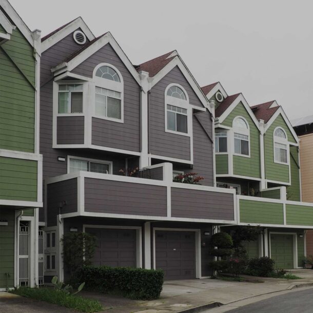 Row of different colored townhouses.