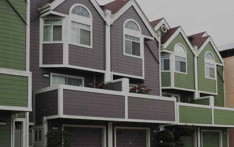 Row of different colored townhouses.