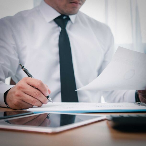 Accountant sitting at desk reviewing spreadsheets.