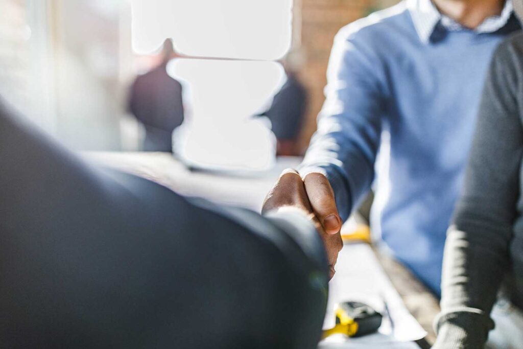 Close up of two business men shaking hands.