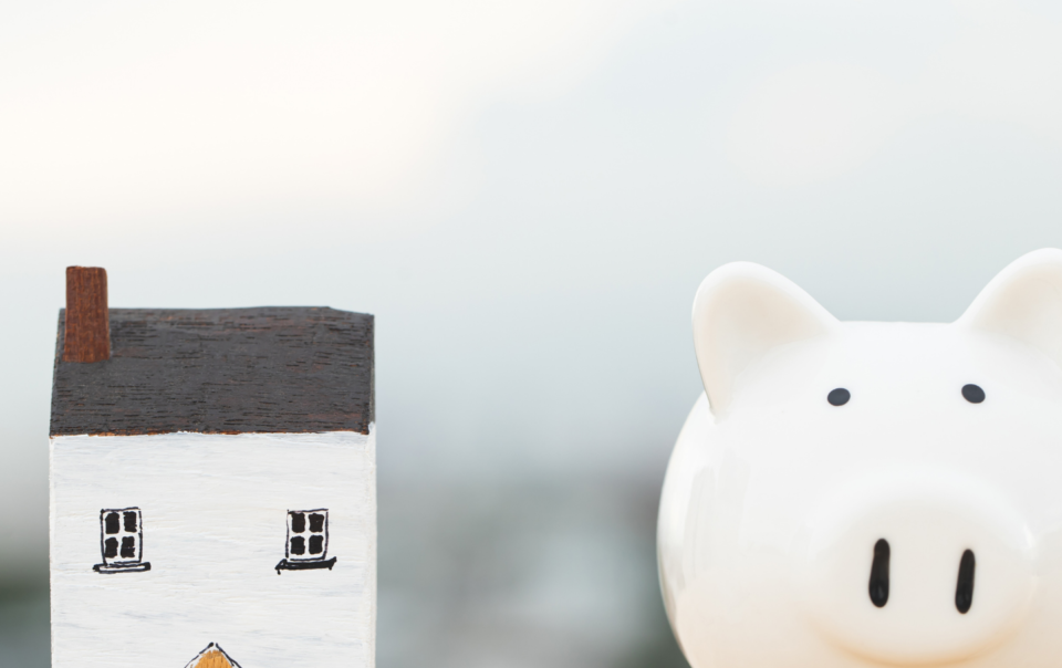 Small house next to a white piggy pank.