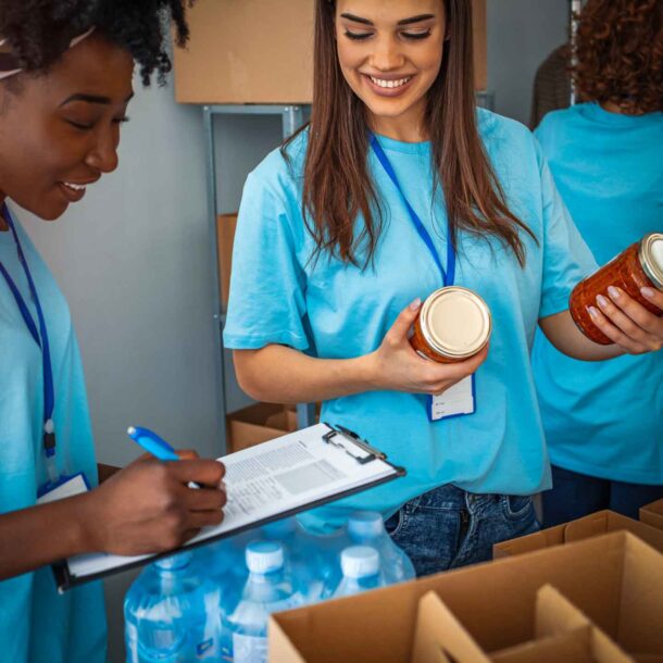 Two female volunteers going over food inventory.