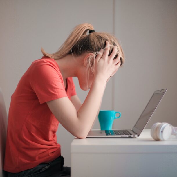 Woman looking frustrated at computer
