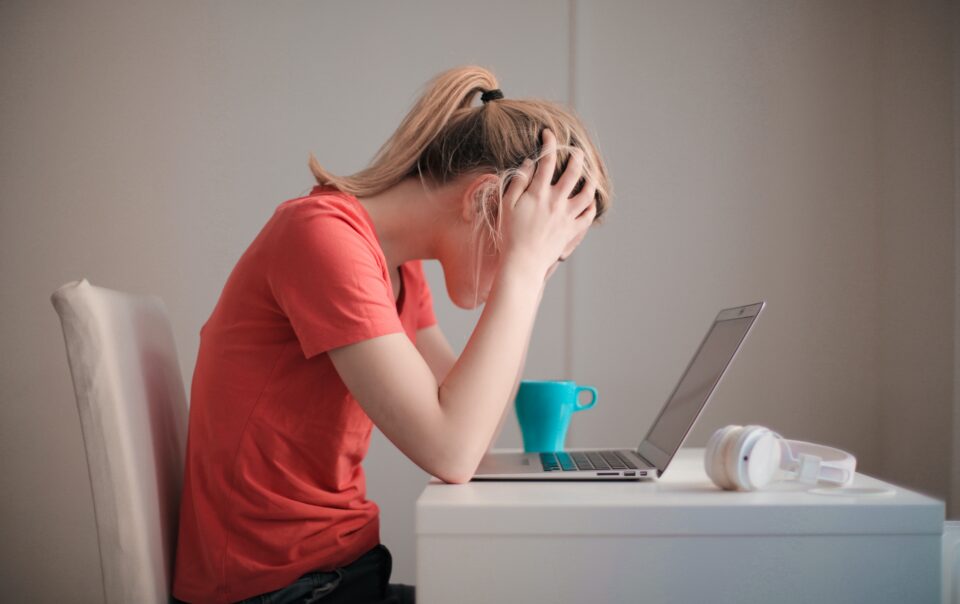 Woman looking frustrated at computer