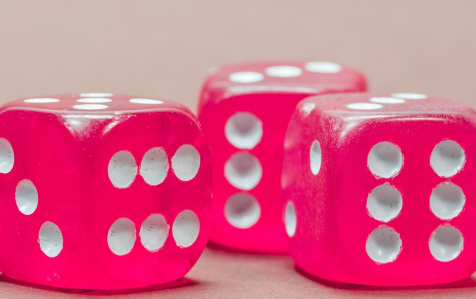 3 pink dice with white pips