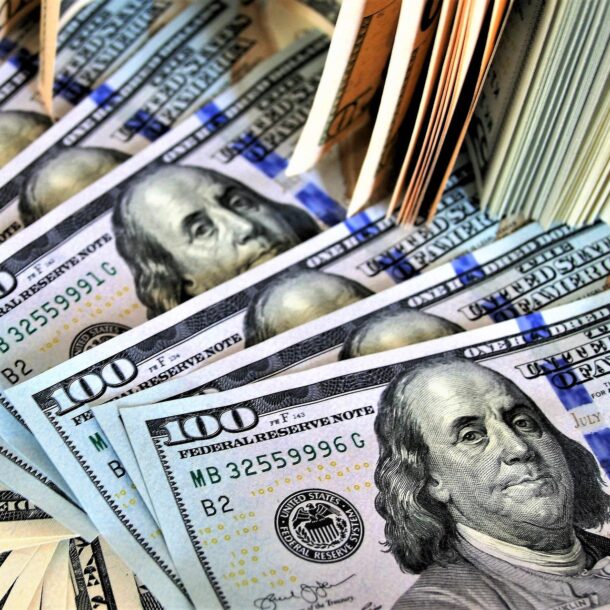 A pile of $100 bills spread out.
