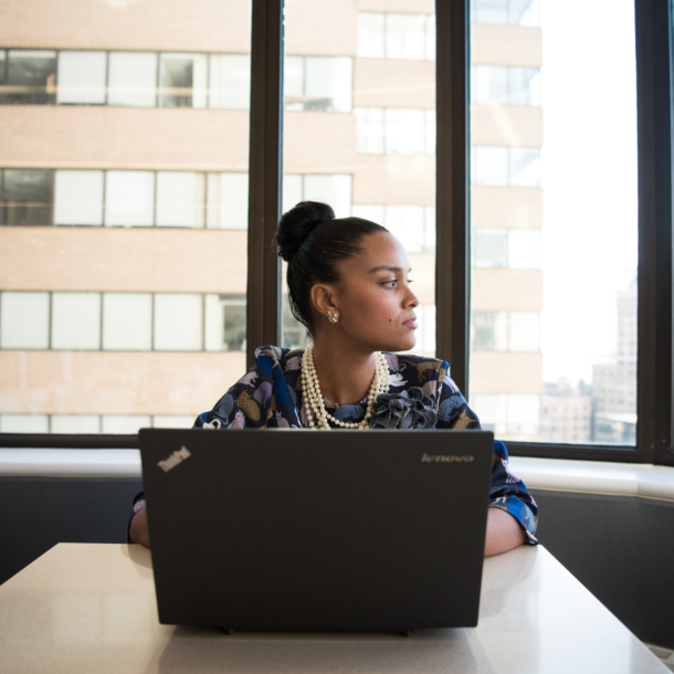 Woman Sits in Front of Black Laptop Computer