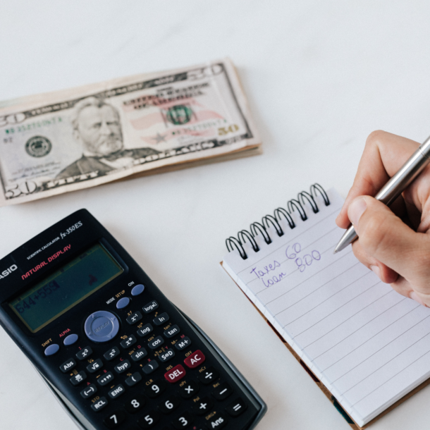 financier planning budget writing numbers in notebook