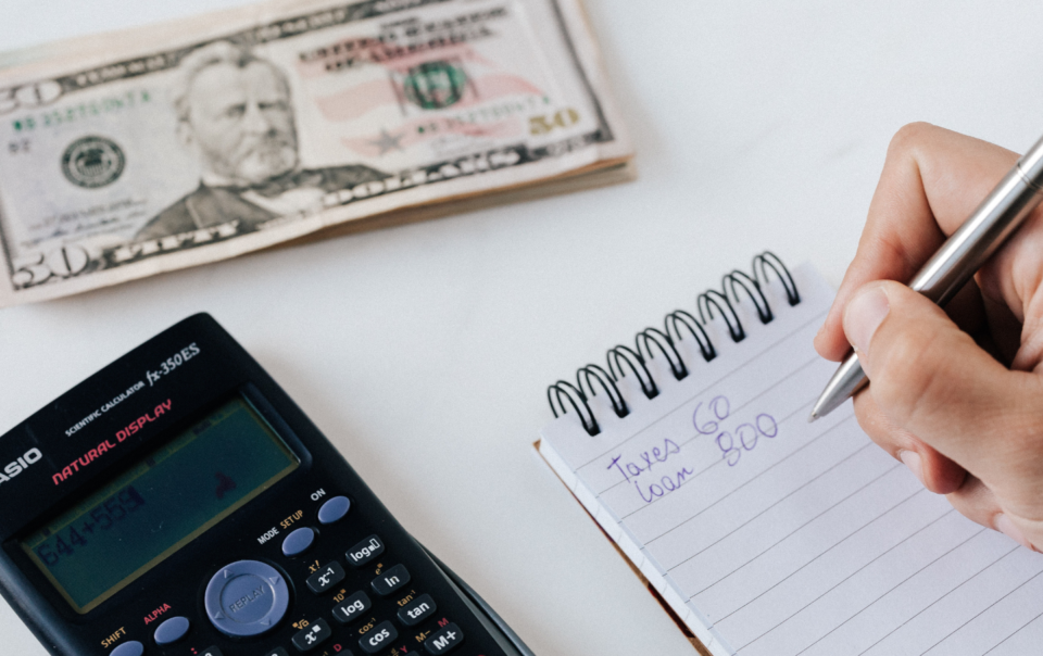 financier planning budget writing numbers in notebook