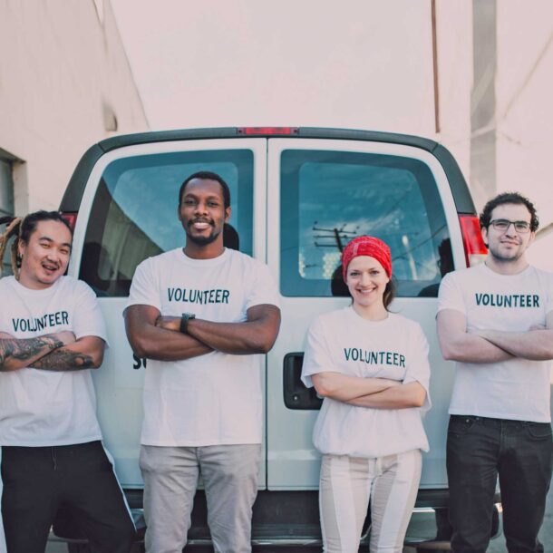 Local volunteers standing in front of a van.