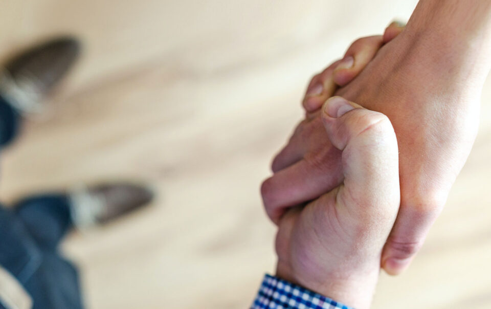 Two people shaking hands.